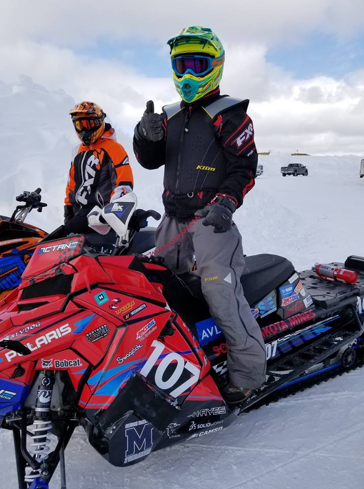 Two guys on two snowmobiles